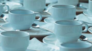 Many blue cups and saucers are arranged on a table video