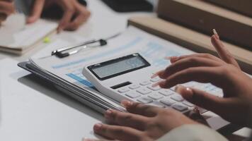 A person using a calculator on a desk video