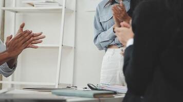 A group of people clapping at a meeting video