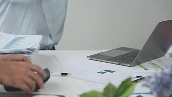 A man is using a laptop computer and papers video