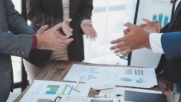 Business people shaking hands at a table video