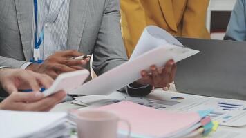 Business people working on paperwork at a desk video