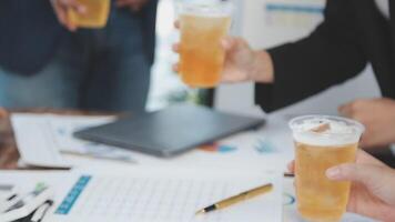 Business people toasting with drinks on a table video