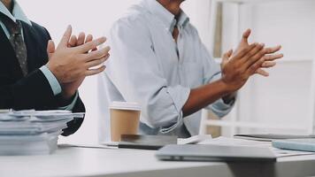 Two business people clapping at a desk video