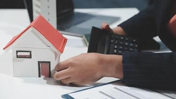 A person is using a calculator to calculate the value of a house video
