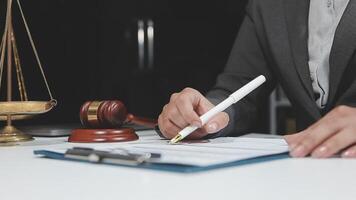 A lawyer signing a document in front of a judge's gavel video