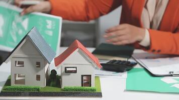 A woman is holding a model of a house on a desk video