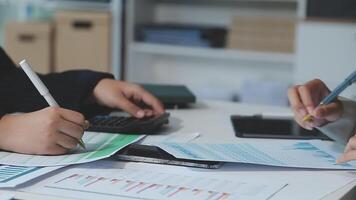 Two people working on paperwork at a desk video