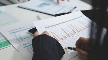 Business people working on papers with graphs video