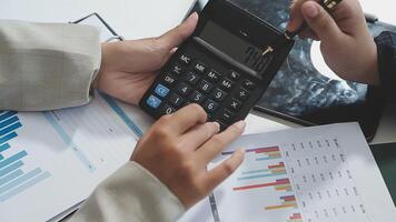 Two people are using a calculator to make a financial decision video