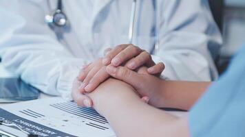 A doctor holding hands with a patient video