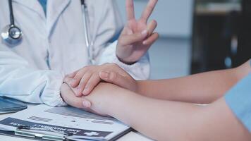 A doctor holding hands with a patient video