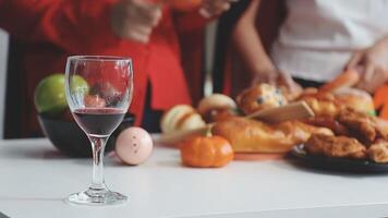 A glass of red wine is on a table with food video
