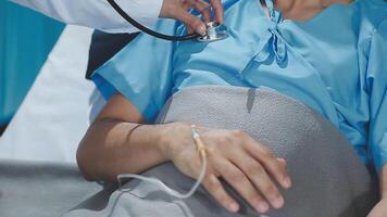 A doctor is checking the heart rate of a patient video