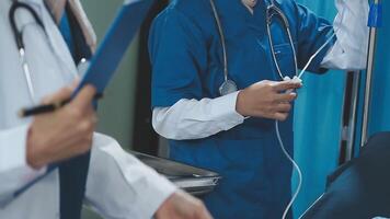 A doctor is holding a stethoscope while another is holding a clipboard video