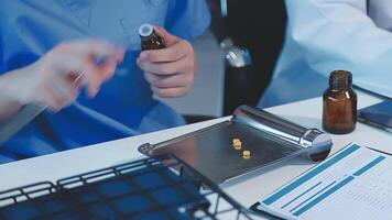 Two doctors are working on a computer and a bottle video