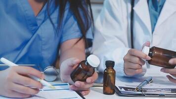 Two doctors are holding bottles of medicine video