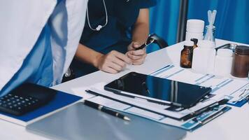 A doctor is working on a laptop while sitting at a desk video