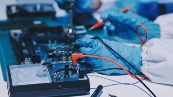Hands working on electronic components in a laboratory video