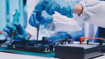 A person in a lab coat is working on a computer video