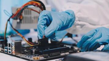 A person in blue gloves is working on a computer video