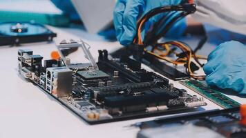A person in blue gloves is working on a computer video
