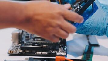 A person is working on a computer motherboard video