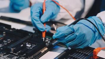 A person in blue gloves is working on a computer video