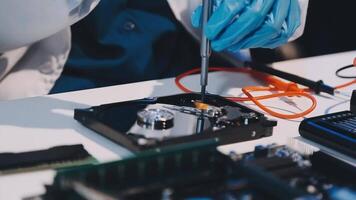 A person in blue gloves is working on a computer video