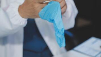 A person in a lab coat holding a blue cloth video
