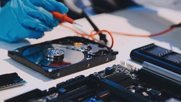 A person in blue gloves is working on a computer video