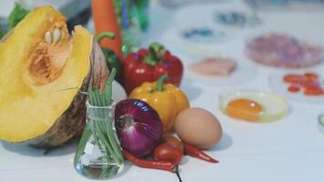 A variety of vegetables and eggs sit on a table video