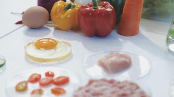 A table with a variety of ingredients including eggs, vegetables, and meat video