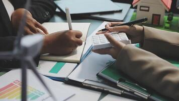 Business people working on a calculator and writing on paper video