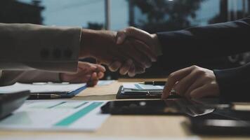 Two business people shaking hands over a table video