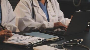 Two doctors working on a laptop video