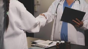 A doctor shaking hands with another person video