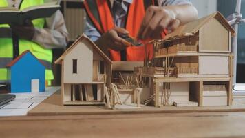 A man is working on a model of a house video