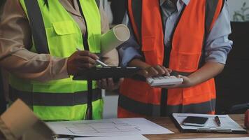 Two construction workers are working on a project video