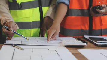 Two people in safety vests working on construction plans video