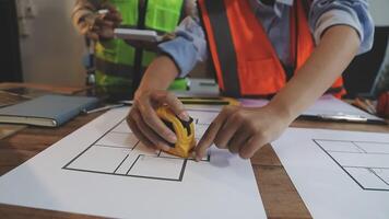 Two people working on a blueprint with a pencil video