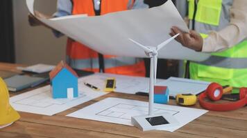 Two people working on a project with a wind turbine video