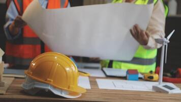 Two people in hard hats and safety vests are working on a construction project video