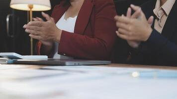 Two business people clapping at a meeting video