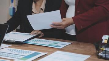 Two business people are working on paperwork at a desk video