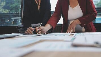 Two business people working on paperwork at a table video