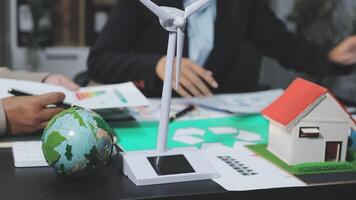 Businessman working on a project with a wind turbine video