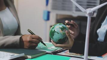 Business people working on a project with a globe video