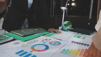 Business people working on a table with graphs and papers video