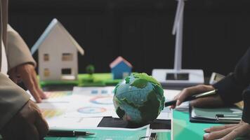 Business people working on a project with a globe and a house video